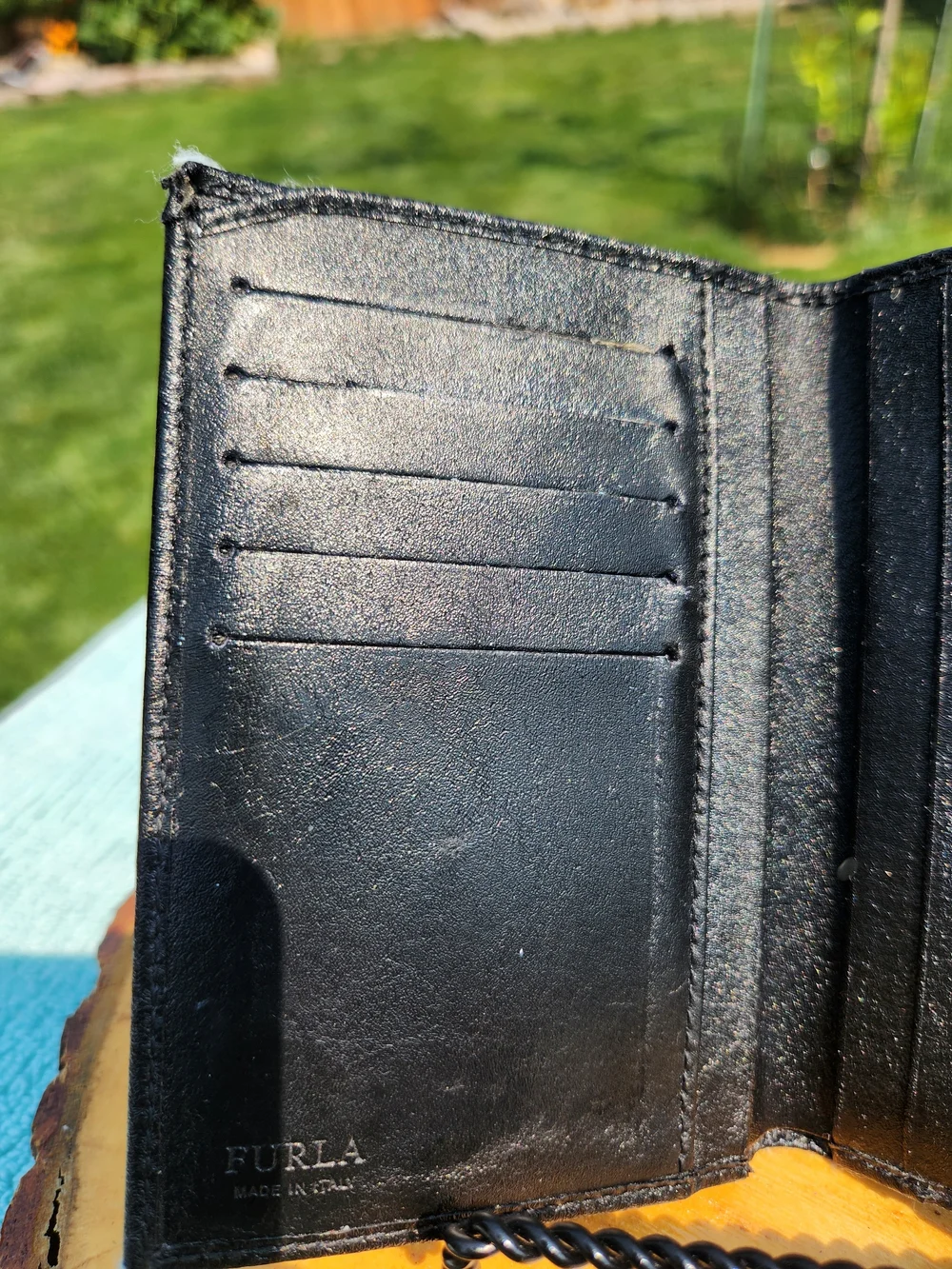 Authentic Furla trifold Compact wallet crafted from smooth black leather.